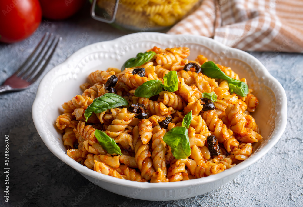 Basil leaves on pasta with arabiata sauce