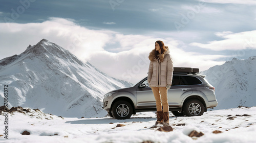 Woman traveling exploring, enjoying the view of the mountains, landscape, lifestyle concept winter vacation outdoors. Female standing near the car in sunny day, travel in the mountains, freedom © Karol
