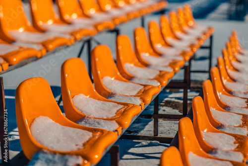 In winter, there are plasma chairs for walks in the park. Soft selective focus. Artificially created grain for the picture photo