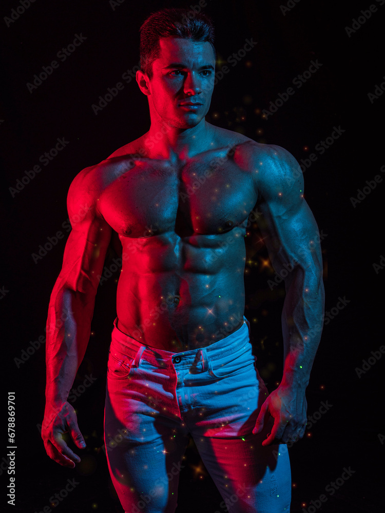 A Strong Display of Masculinity: Flexing Muscles and Striking a Pose in Studio. A man posing for a picture while flexing his muscles A Strong Display of Masculinity: Flexing Muscles and Striking a Pose in Studio. A man posing for a picture while flexing his muscles