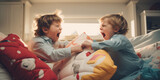 Siblings having fight with pillows at home. Concept of conflict and family relation.