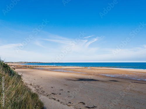 Cambois beach in Northumberland at low tide with old sewage pipe.