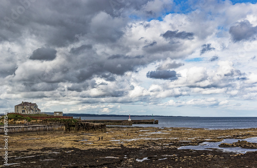 Northumberland coastal landscape with dramatic cloud at low tide