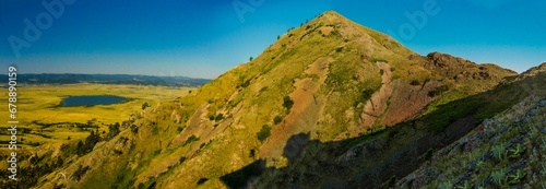 Aerial view of mountain landscape surrounded by greenery fields in Bear Butte State Park