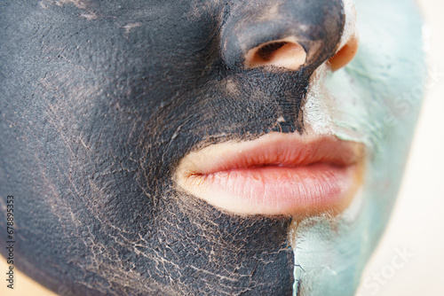 Girl black and green mud mask on face photo