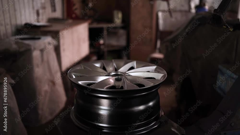 Car wheel service. Mechanic changing tires and rims, balancing the wheels Car wheel service. Mechanic changing tires and rims, balancing the wheels