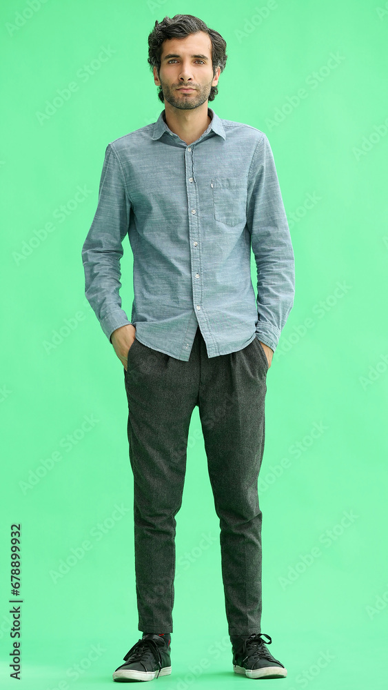 full-length portrait of a young man. standing isolated on green background full-length portrait of a young man. standing isolated on green background