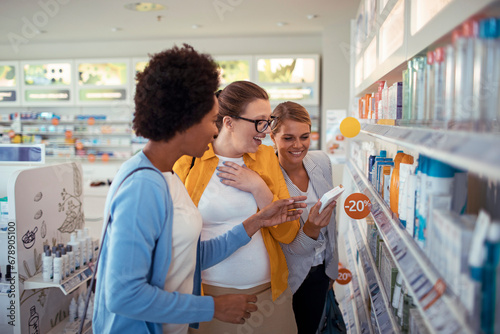 Female customers choosing product at pharmacy drugstore photo