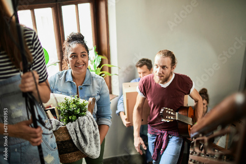 Diverse and young group of college students moving into their new dorm together and moving their boxes and bellongings photo