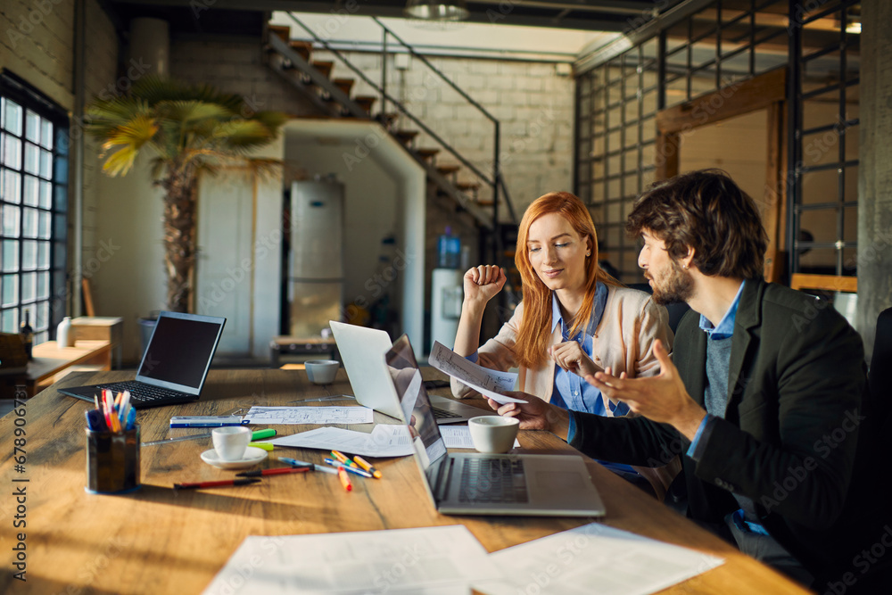 Diverse coworkers Analyzing Document in Office Setting Diverse coworkers Analyzing Document in Office Setting