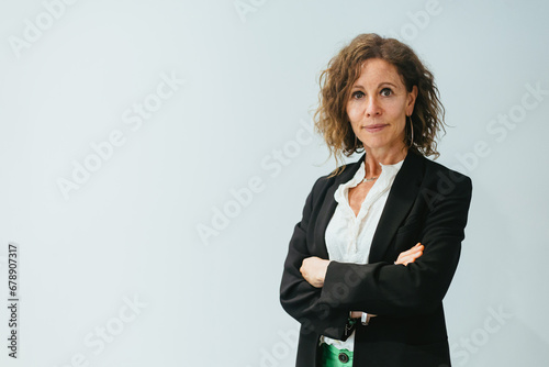 Confident Businesswoman: Woman 50+ Crosses Arms in White Background Shot