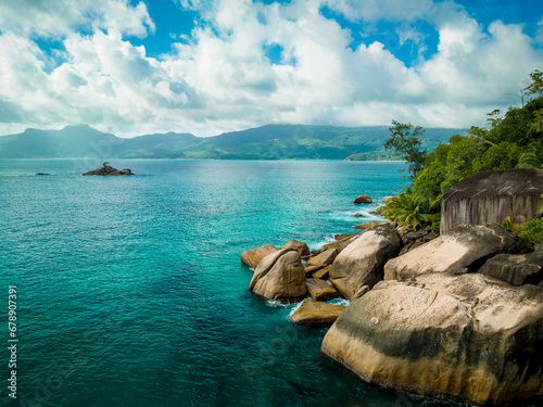 Big granite rocks and turquoise ocean water. Summer landscape on a tropical island. Tropical landscape with sunny sky. Seyshelles, Mahe