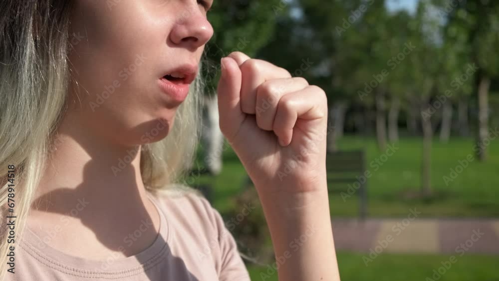 Stressed teen with flower allergy in park. A teen girl suffer from flowers allergy and coughing in park in the sun rays. Stressed teen with flower allergy in park. A teen girl suffer from flowers allergy and coughing in park in the sun rays.
