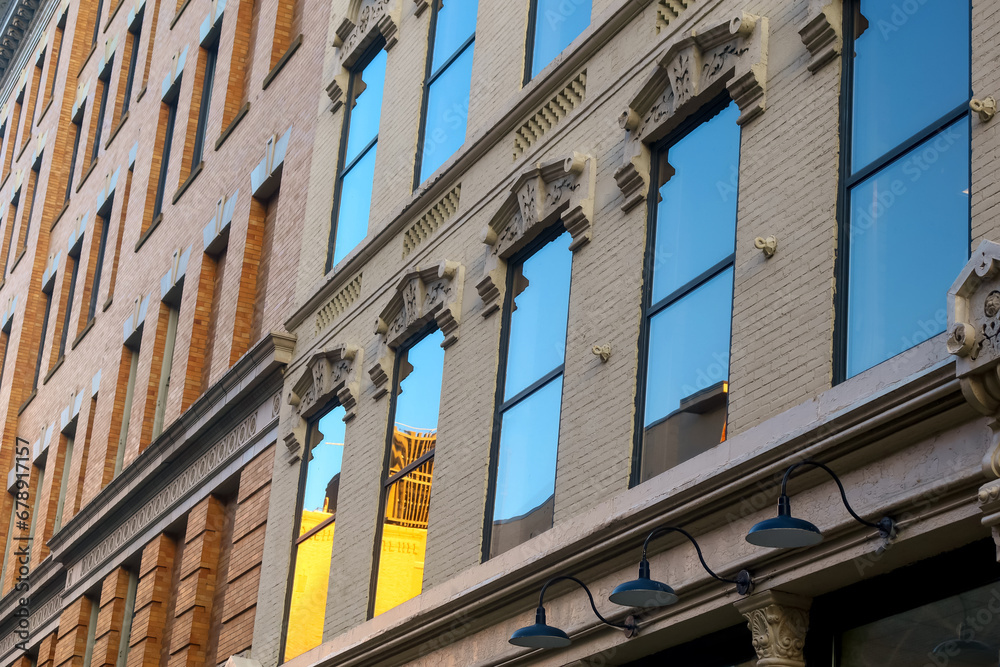 Exterior view of historic building with glass windows, sky reflection in downtown Grand Rapids, Michigan