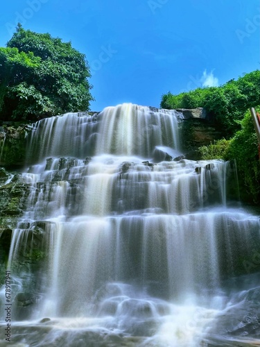Vertical shot of the beautiful Kintampo Waterfalls in Ghana under the clear blue sky