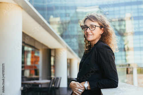 Business Casual Outdoors: Mature Woman 50+ in Black Shirt, Jeans at Office