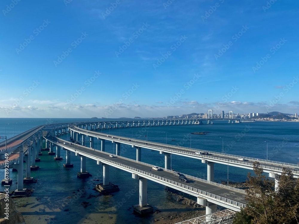 High-angle view of bridge road on blue seawater in Dalian, China.