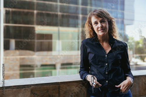 Mature Professional: Woman Over 50 in Black Shirt, Jeans Outside Office