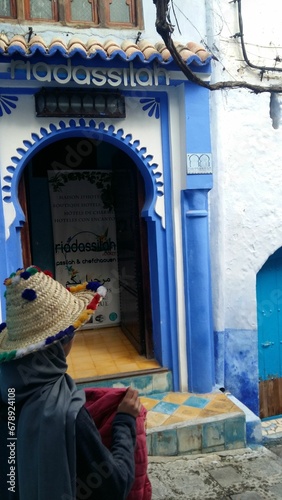 Tourist walking the streets of Souika in Chefchaouen, Morocco © Wirestock