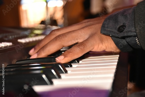 Close-up view of a hand playing on the digital piano