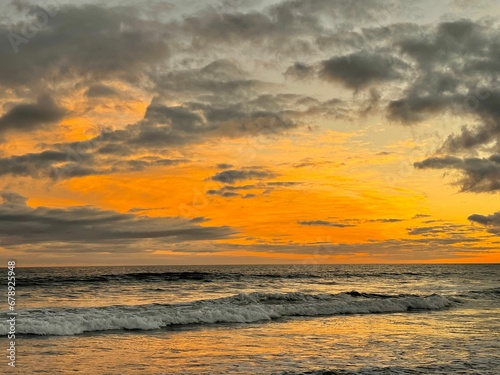 Scenic shot of a wavy sea under the fiery sky at sunset  cool for background