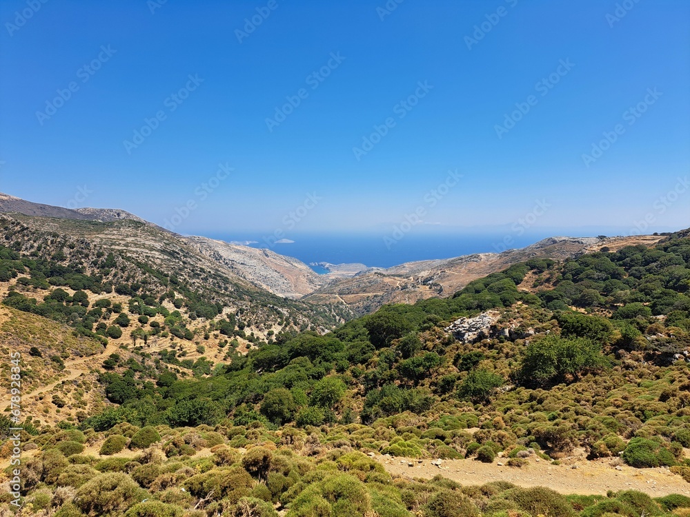 Landscape scene of Naxos Island green canyons in Greece with blue sky on the horizon