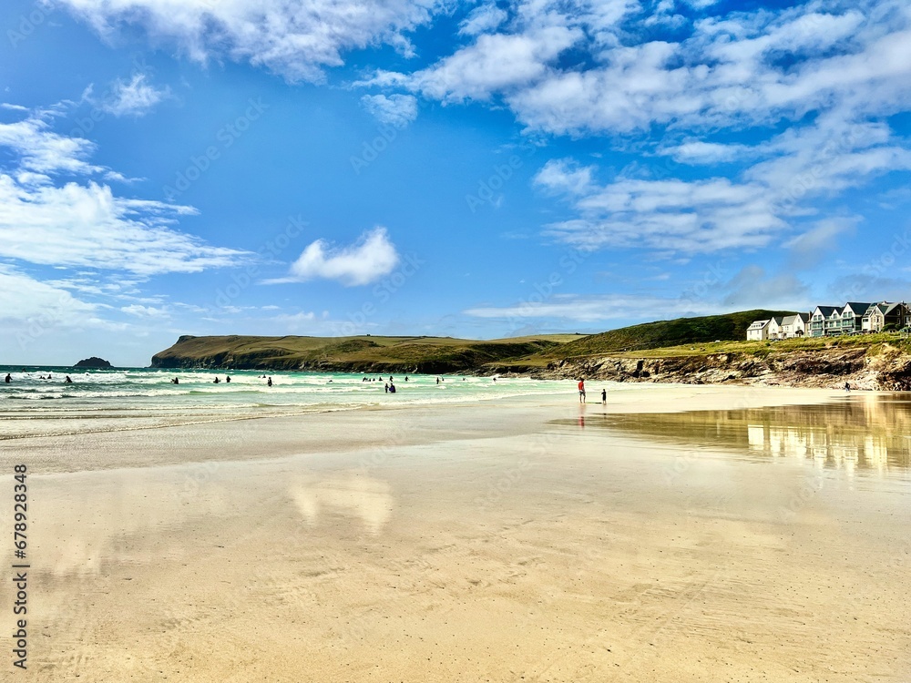 the beach is clean and empty with people walking along it