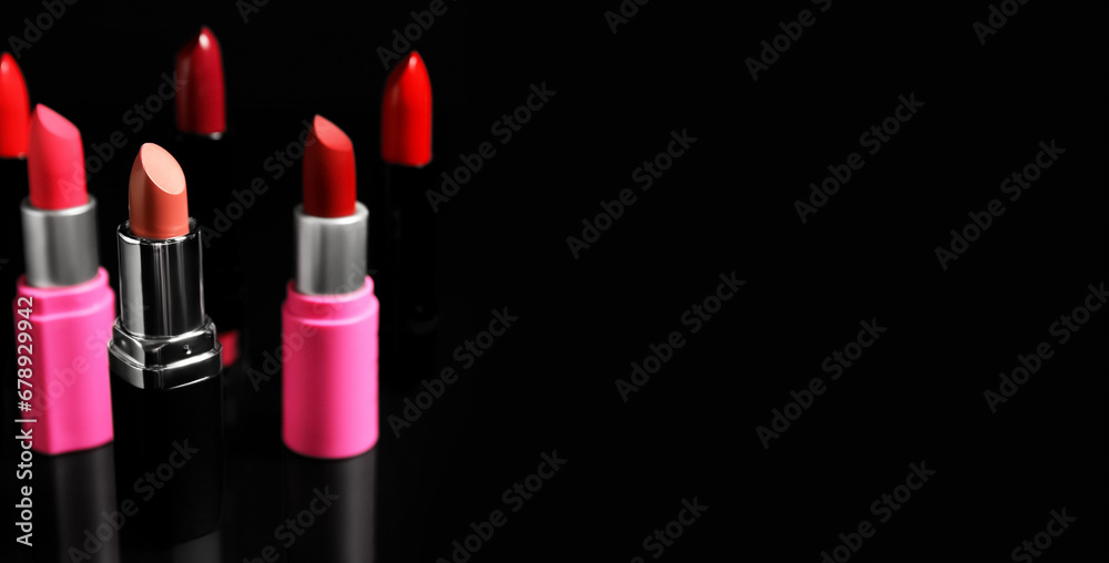 Obraz premium Many lipsticks on black background with space for text