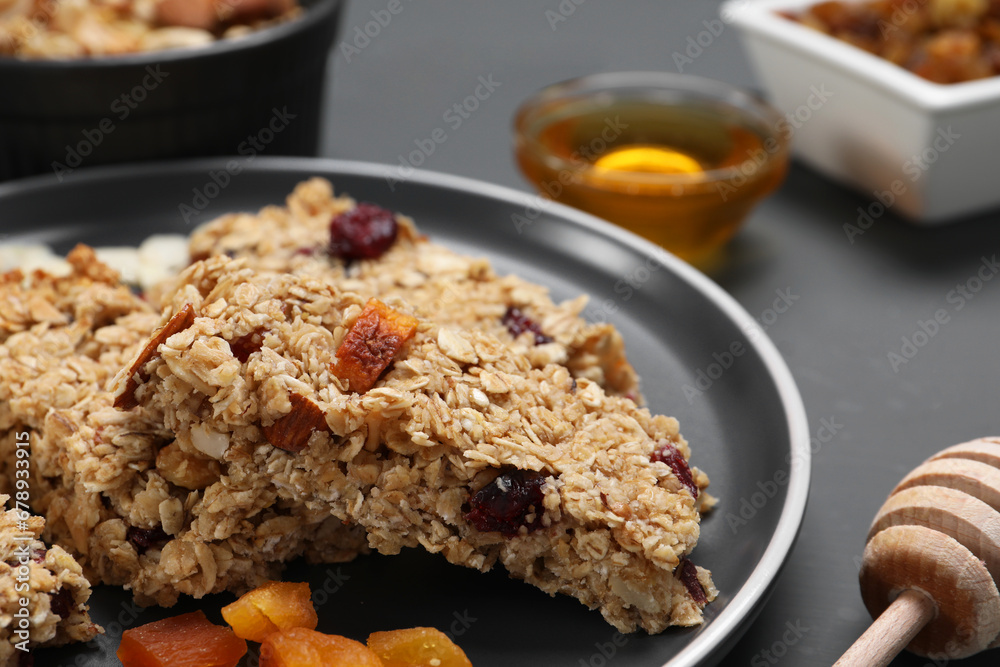Tasty granola bars on grey table, closeup Tasty granola bars on grey table, closeup