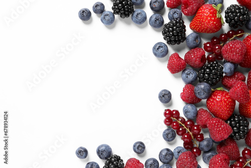 Many different fresh berries on white background, flat lay. Space for text photo