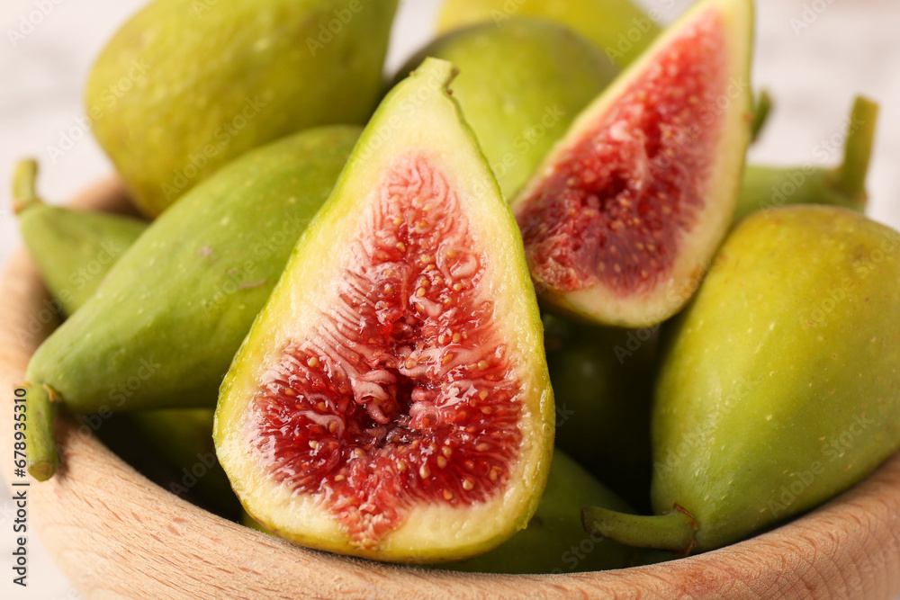 Cut and whole green figs in bowl, closeup Cut and whole green figs in bowl, closeup