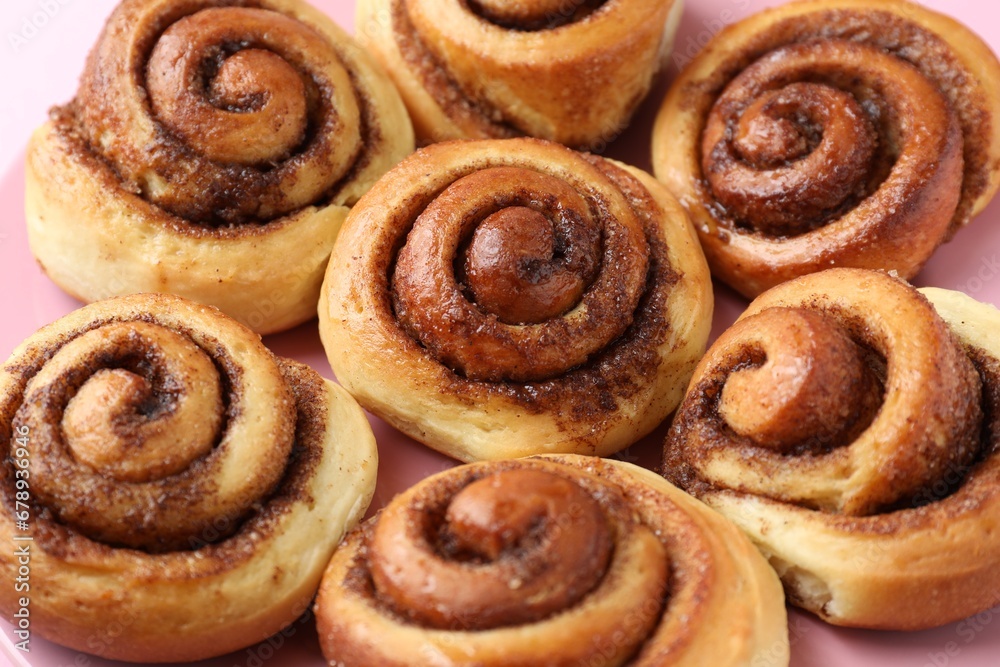 Plate with many tasty cinnamon rolls, closeup Plate with many tasty cinnamon rolls, closeup
