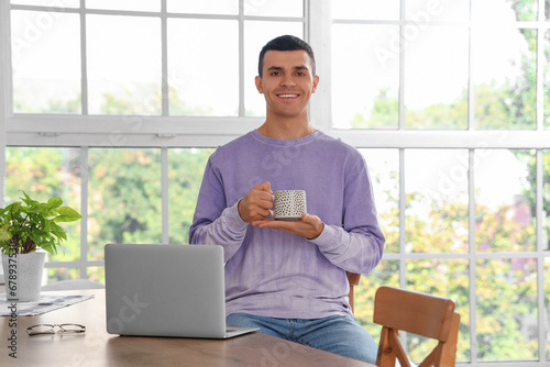 Smiling young man holding a...