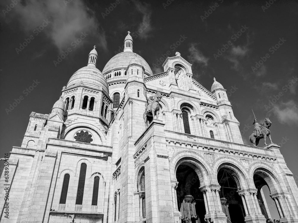 Low angle grayscale of the Basilica of the Sacred Heart of Paris catholic church in Paris, France