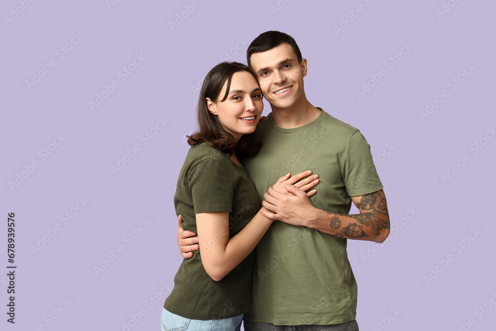 Loving young couple hugging on lilac background Loving young couple hugging on lilac background