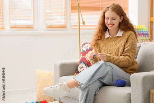 Young woman knitting with c...
