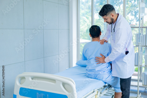 Doctor physiotherapist treating lower back pain patient after while giving exercising treatment on stretching in the hospital, Rehabilitation physiotherapy concept.
