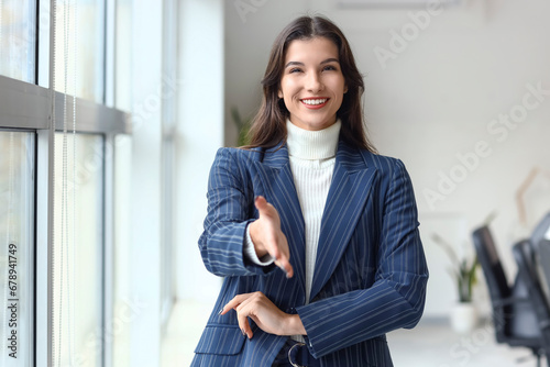 Young businesswoman reachin...
