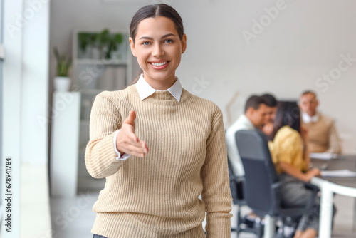 Young businesswoman reachin...