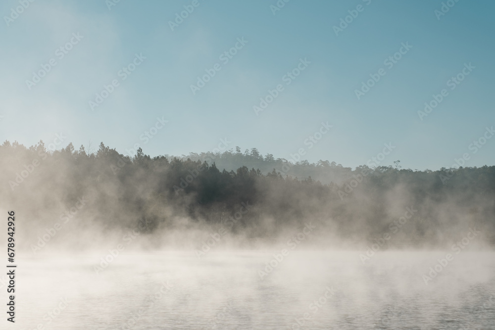 good weather  with fog at the calm lake in  the morning