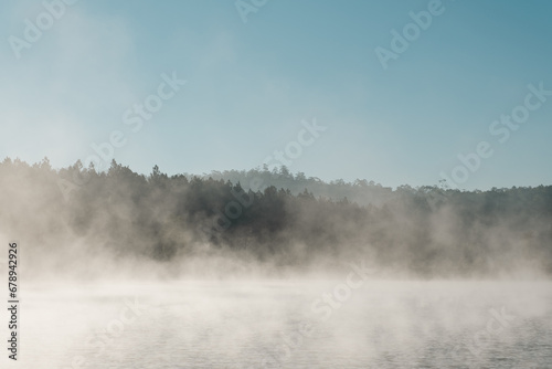 good weather with fog at the calm lake in the morning