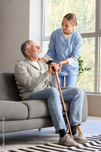 Senior man with stick and n...