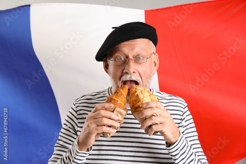 Senior man eating tasty cro...