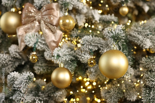 Beautiful decorated Christmas tree with baubles and lights as background, closeup