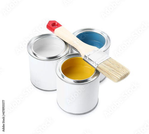 Cans of colorful paints with brush isolated on white