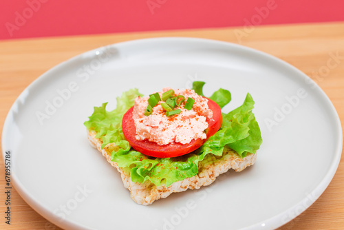 Rice Cake Sandwich with Tomato, Lettuce, Fish Cream and Green Onions on White Plate. Easy Breakfast. Diet Food. Quick and Healthy Sandwiches. Crispbread with Tasty Filling. Healthy Dietary Snack