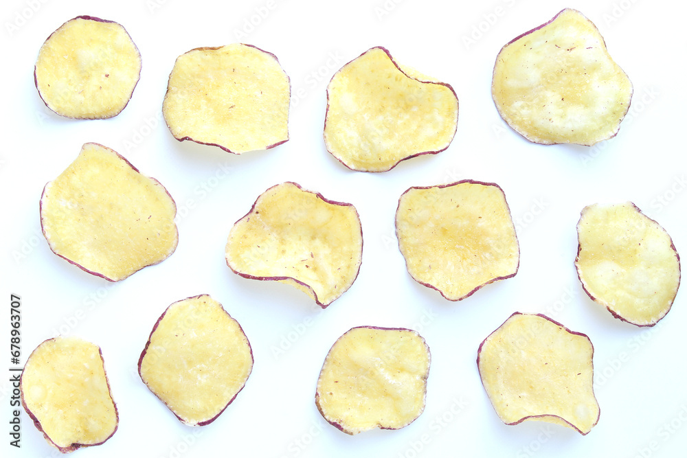 Various sweet potato chips on white background. Various sweet potato chips on white background.