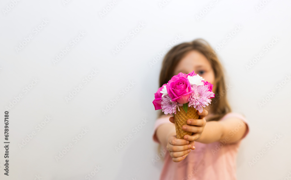 A little girl holding a flower ice cream 
