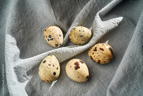 Quail eggs on a blue apron close-up.
