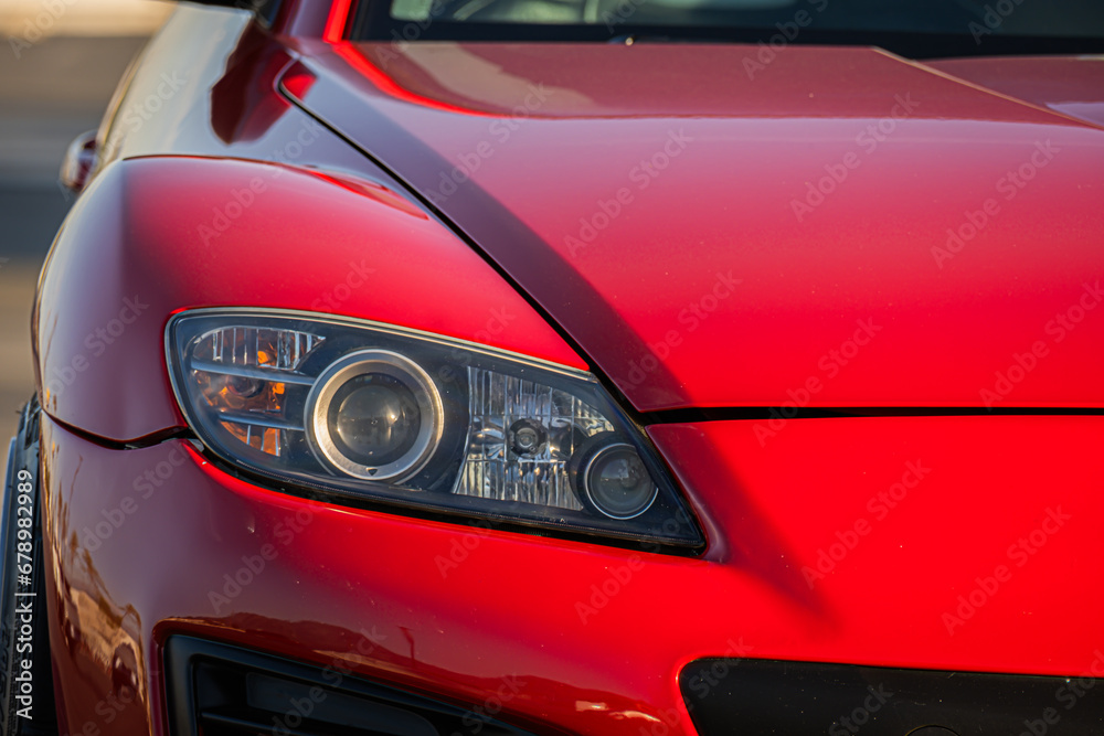 Close Up Red Sports Car Headlight and Bumper